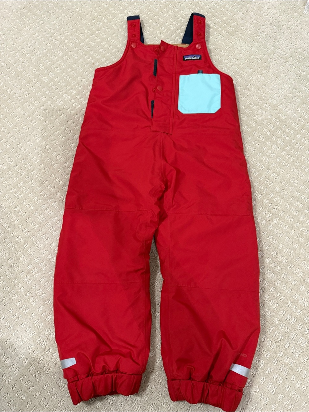 Patagonia Red Toddler Snow-Pile Overalls with Light Blue Pocket.